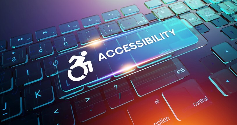 Computer keyboard with a large glowing Accessibility key featuring a wheelchair symbol