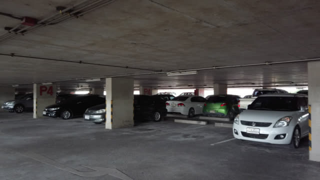 Cars parked in a covered multi-level parking garage